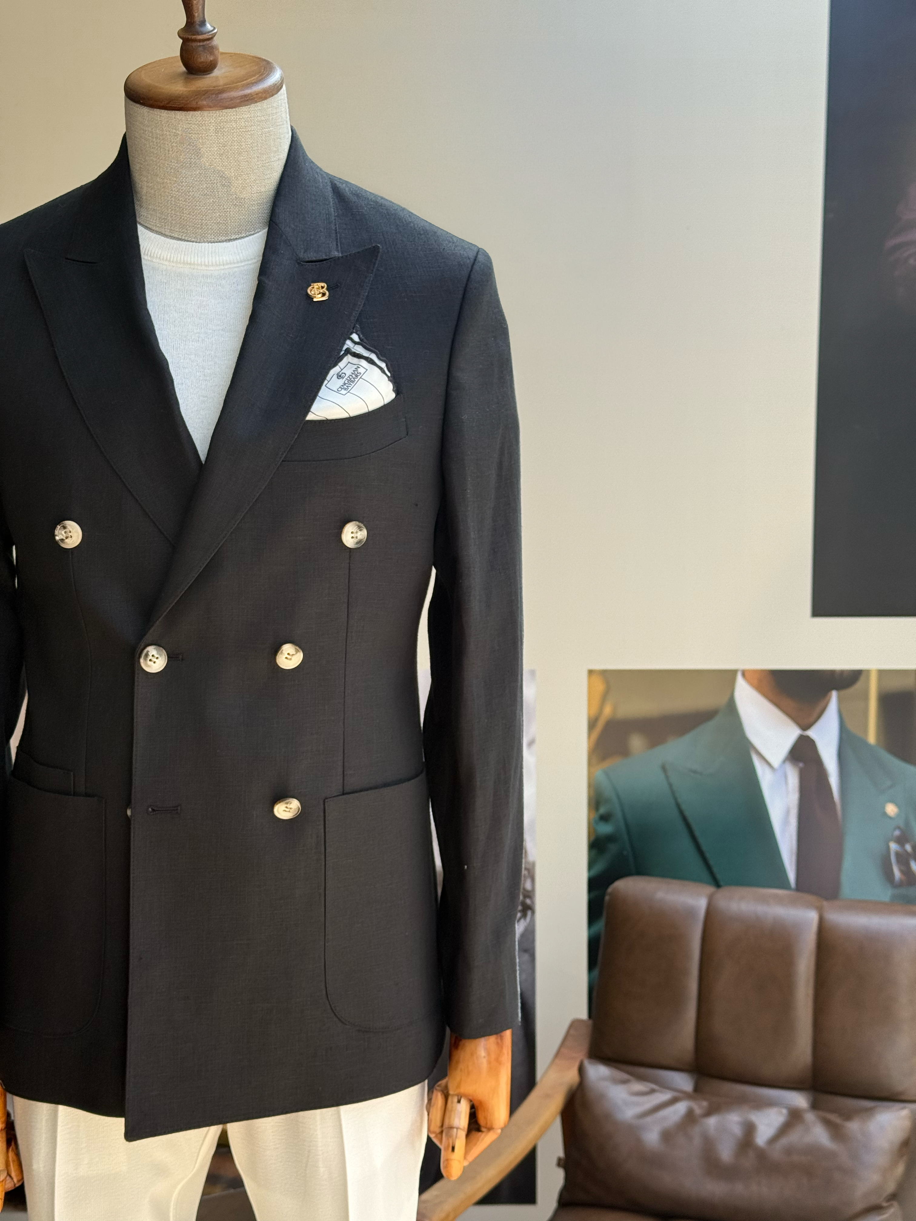 Black double-breasted blazer showing structured back panel and jacket length, back view