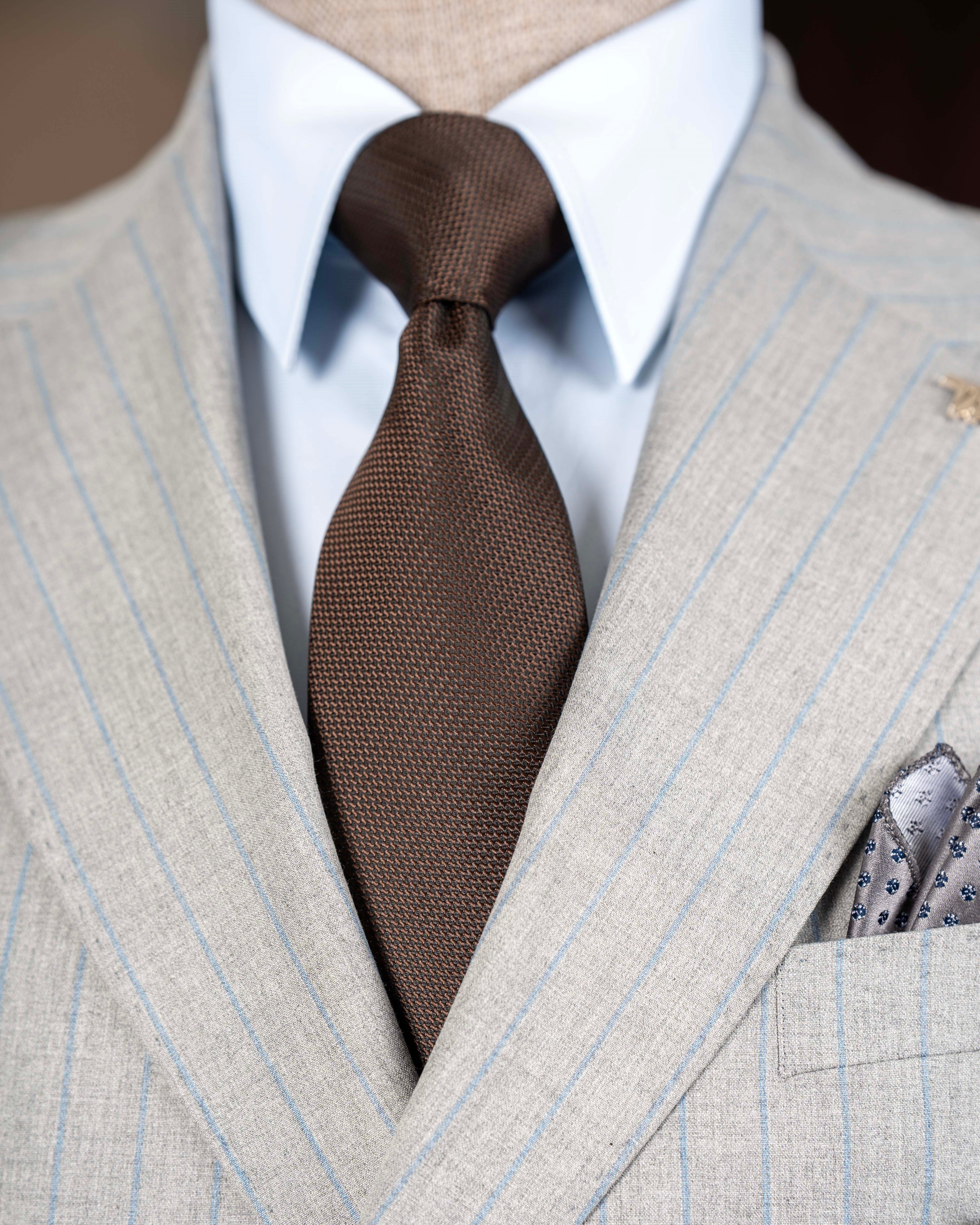 Grey striped double-breasted suit – side profile highlighting jacket structure