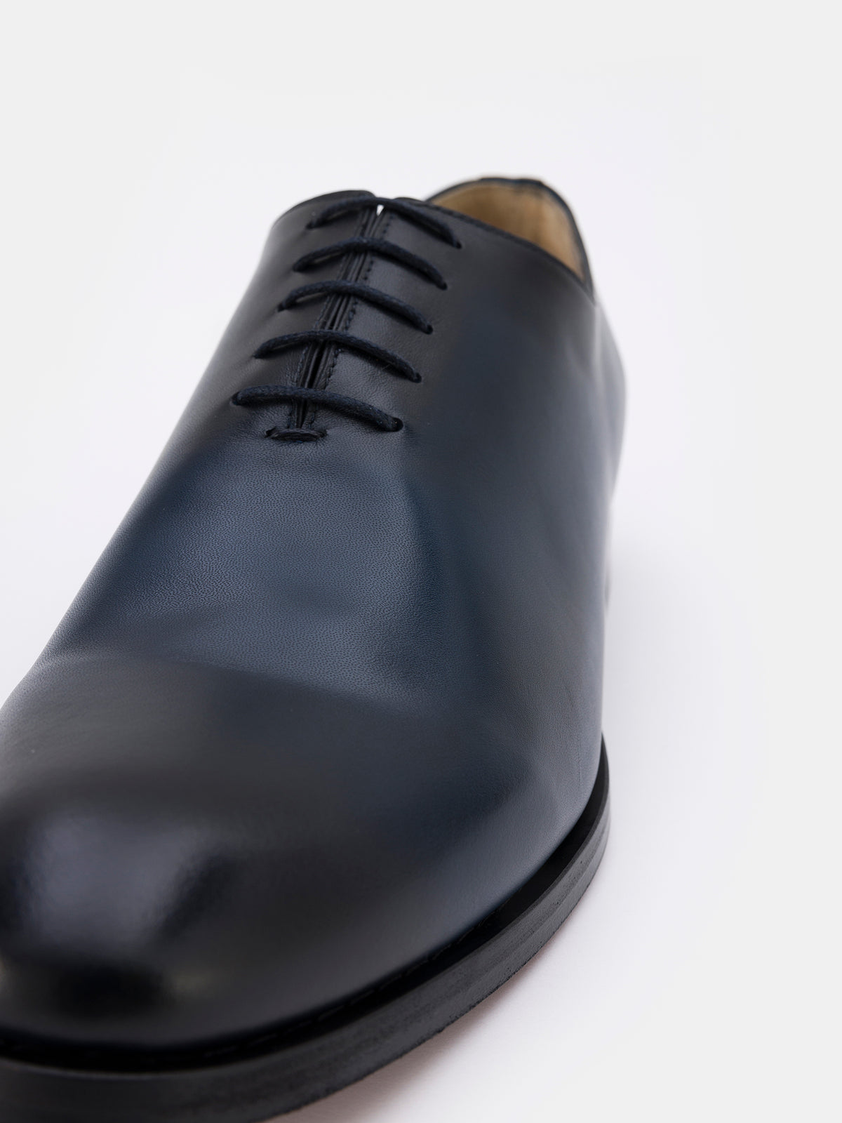 VIOSSI Navy Burnished Leather Oxford styled with navy blue suit for formal business attire