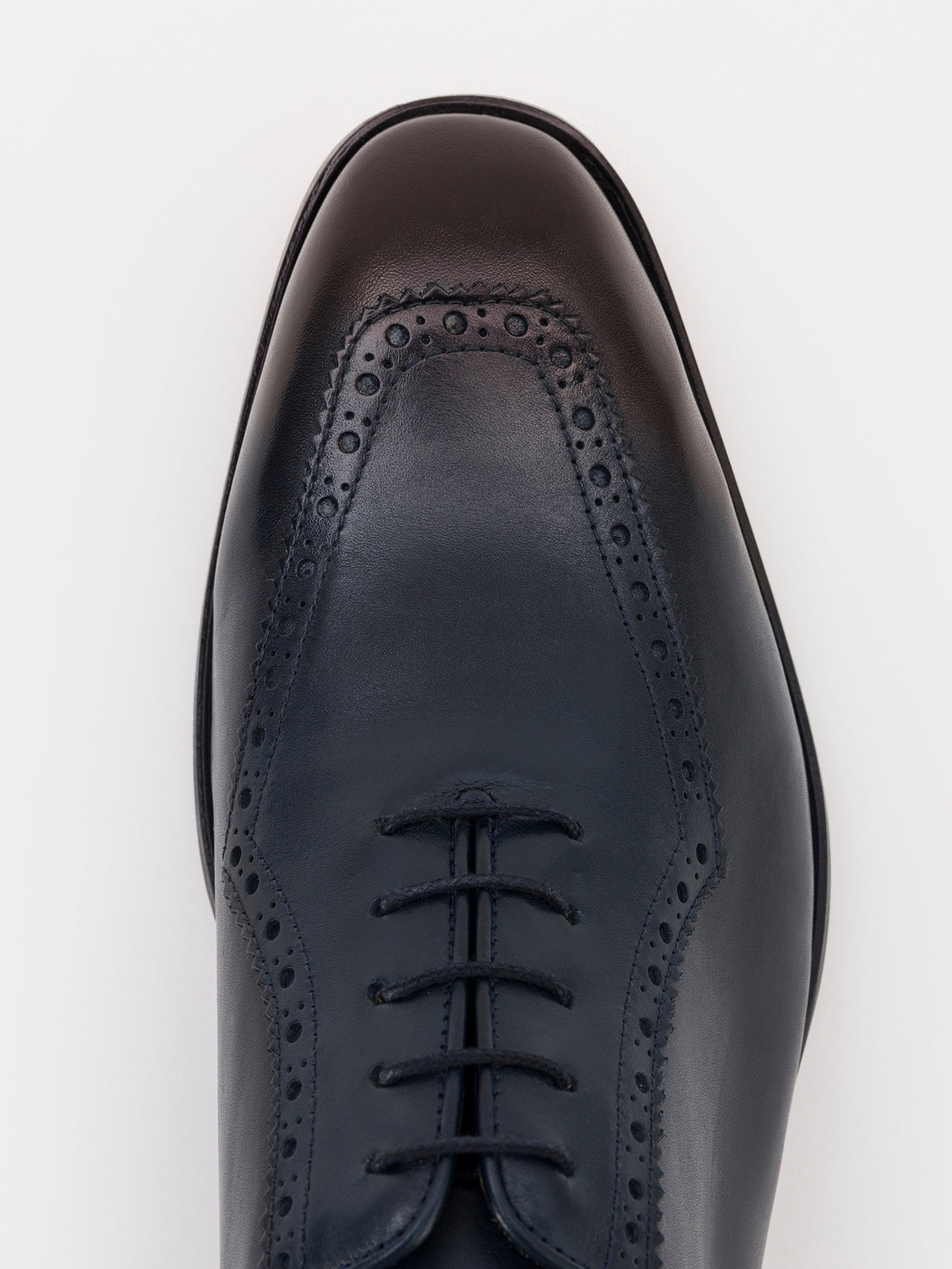 VIOSSI Navy Leather Wing Tip Oxford styled shot showing formal menswear pairing with navy blue suit styling
