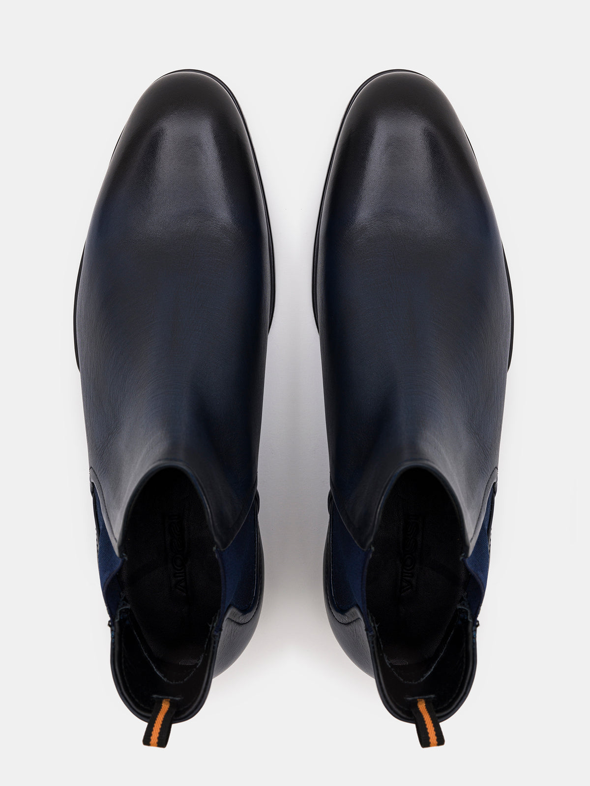 VIOSSI navy boots leather - side angle showing sleek profile and pull tabs of men's Chelsea boots in navy