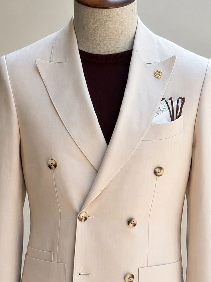 Beige double-breasted blazer showcasing back panel and structured tailoring, rear view