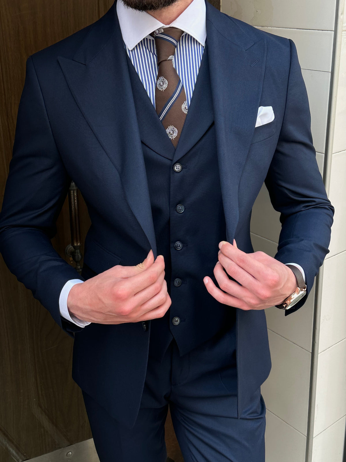 VIOSSI navy slim-fit 3-piece suit styled on model - Italian suit styles perfect for light blue wedding suit events