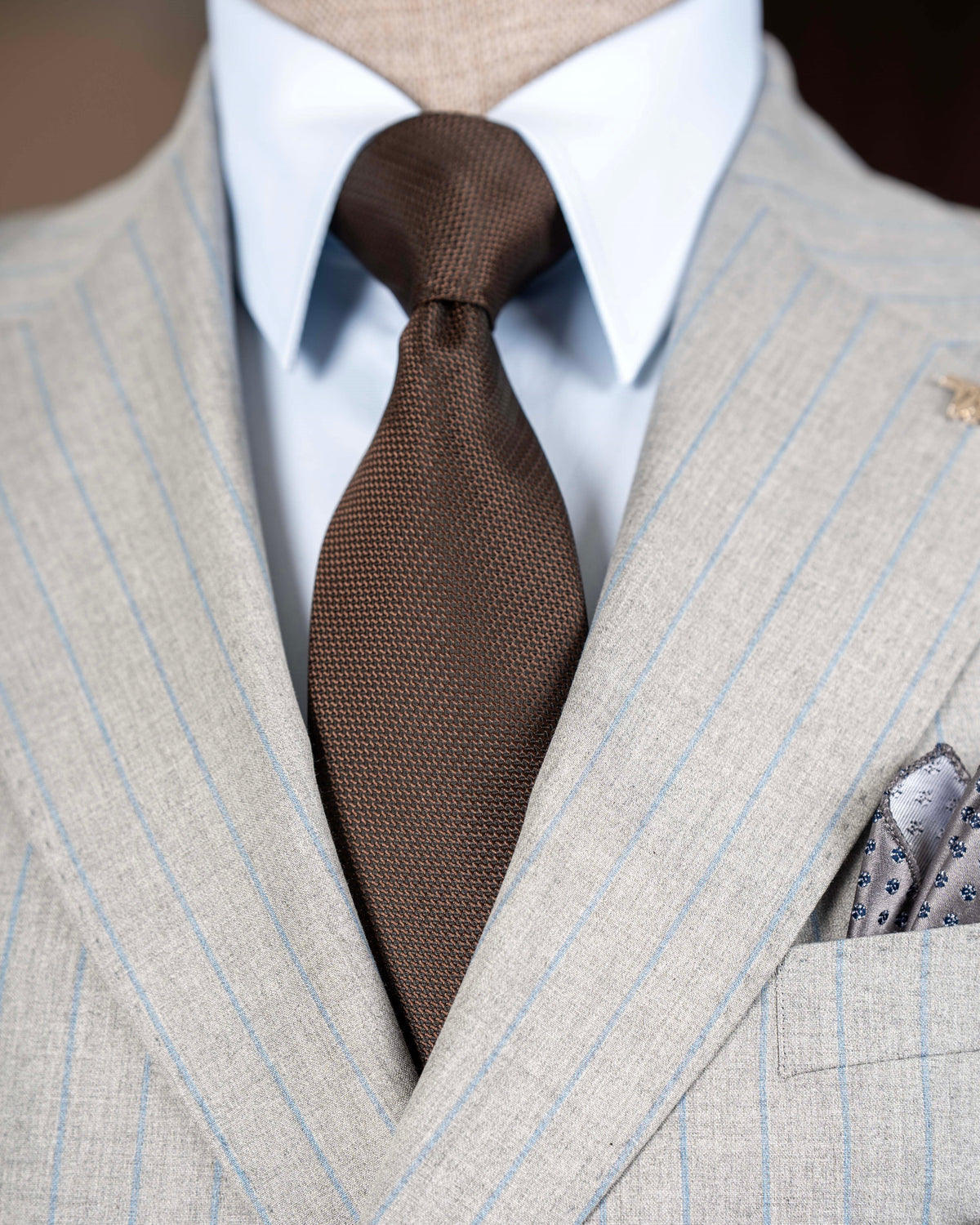 Grey striped double-breasted suit – side profile highlighting jacket structure