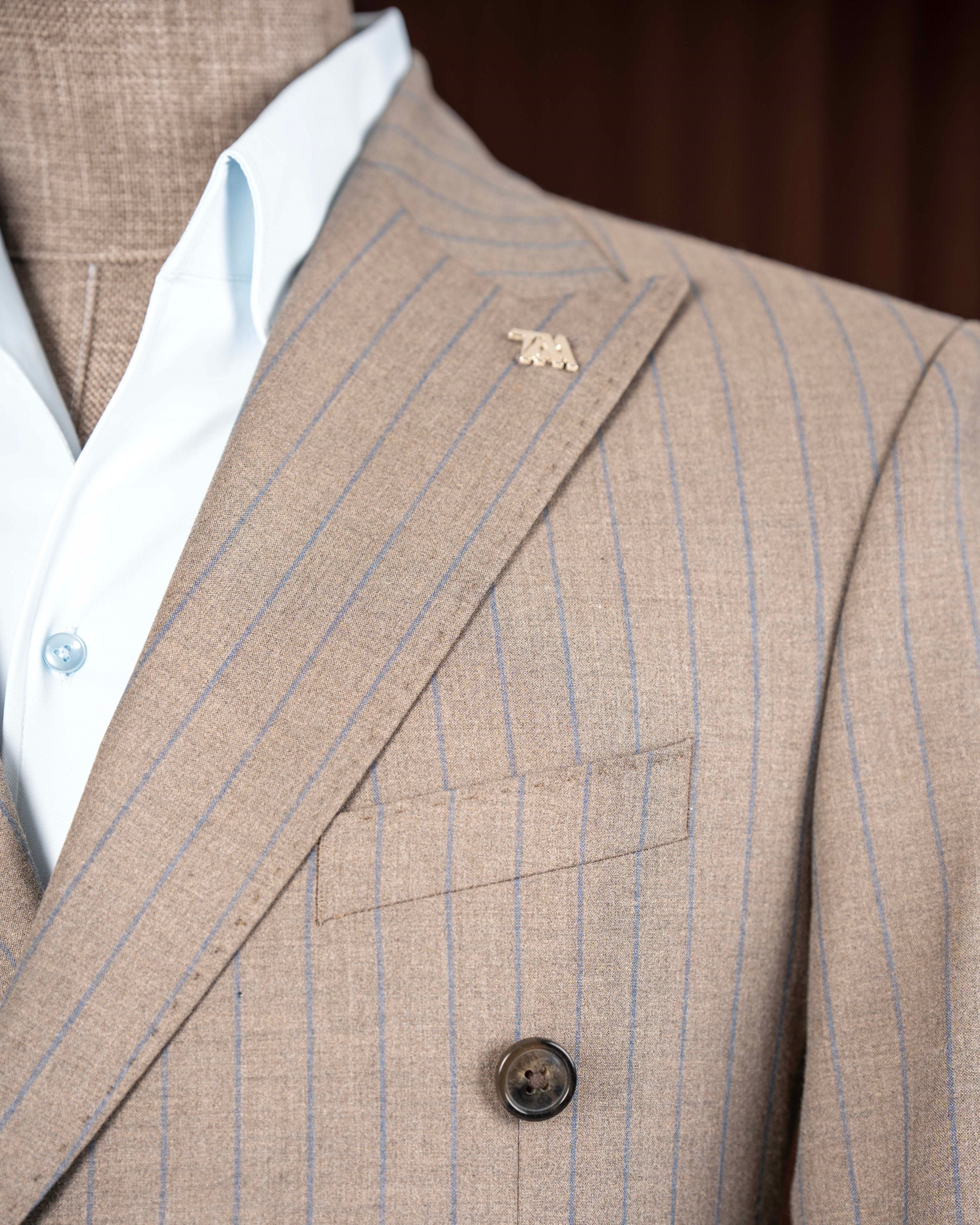 Beige striped double-breasted suit – side profile showing stripe pattern and suit structure